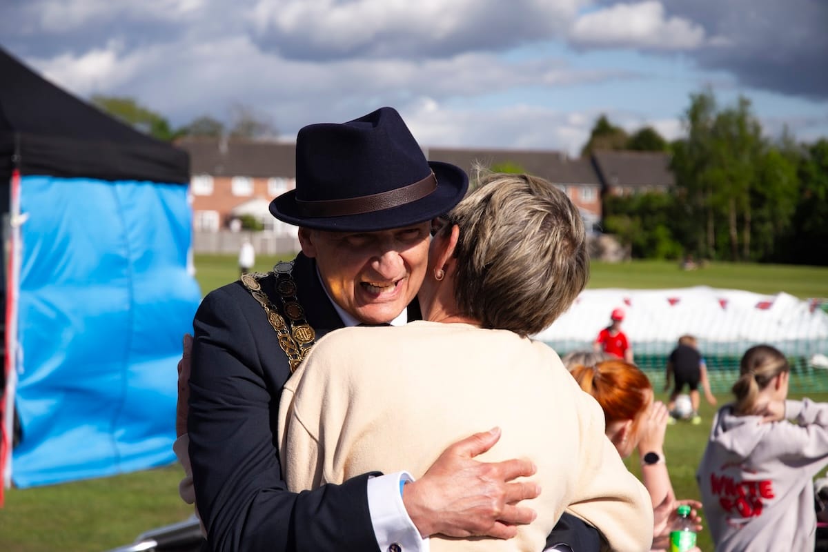Westhoughton town mayor Neil Maher gives a warm embrace to a local resident